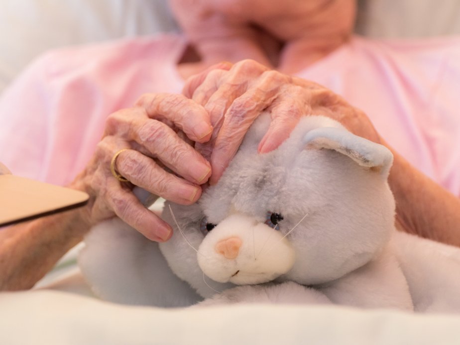 Bewohnerin hält Stofftier.