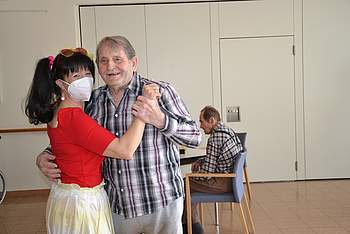 Betreuerin tanzt mit Bewohner