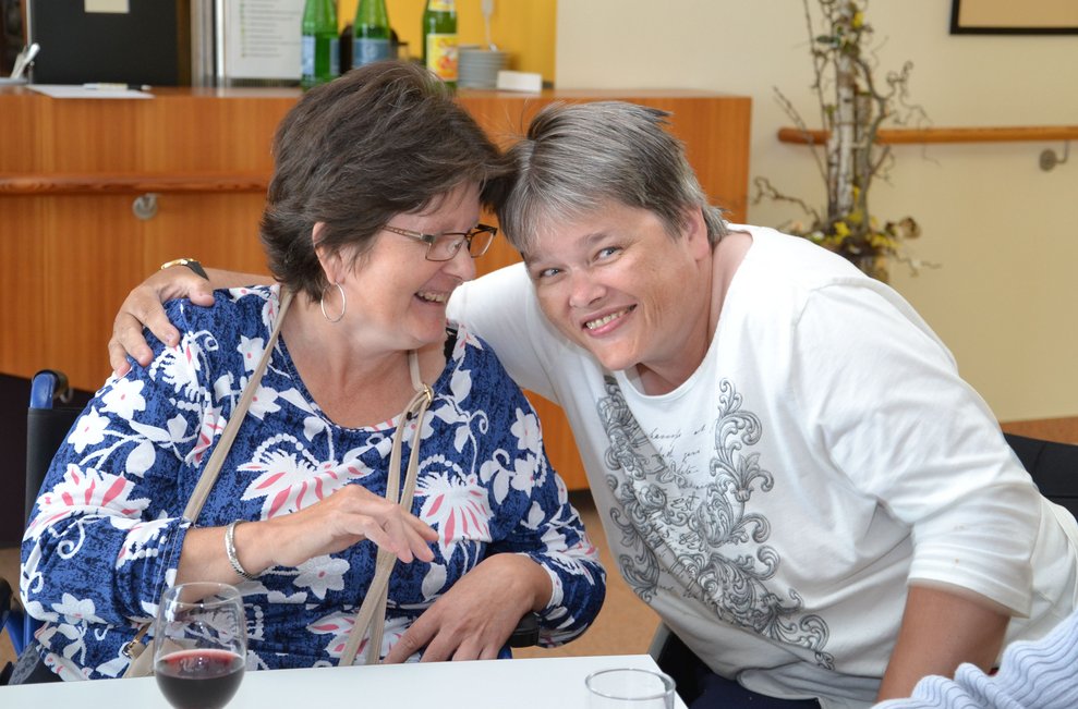 Zwei Frauen lachen zusammen.